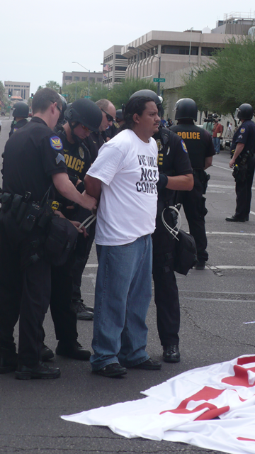 Carlos Garcia arrested as he protests the implementation of SB 1070. Photo Credit: Michael Jordi Valdés