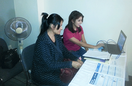 A CPLC staffer assists a Tucson resident in signing up for health coverage.