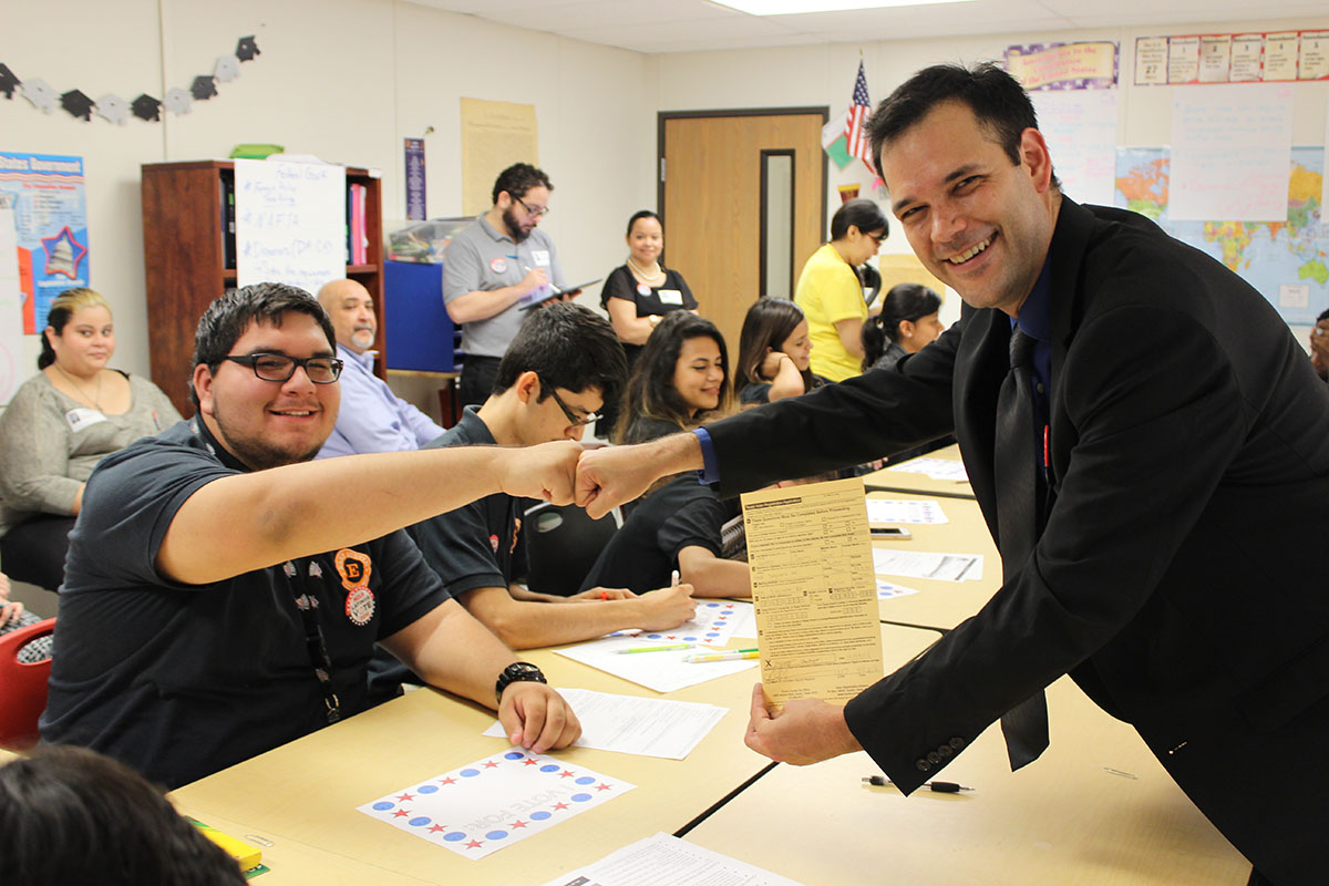 Mr. Johnson, who trained to register voters and was deputized by the state of Texas, registering one of his students during the implementation of the NCLR High School Democracy Curriculum. 