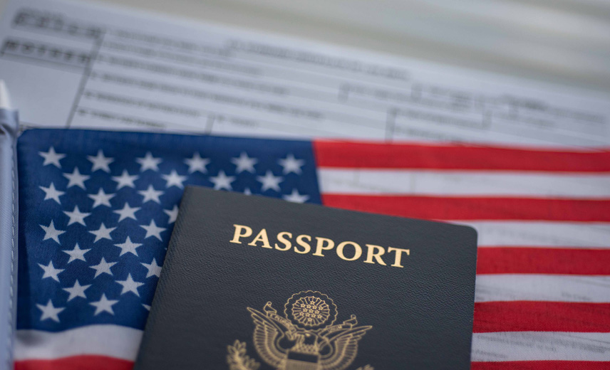 U.S passport on top of the American flag and form.