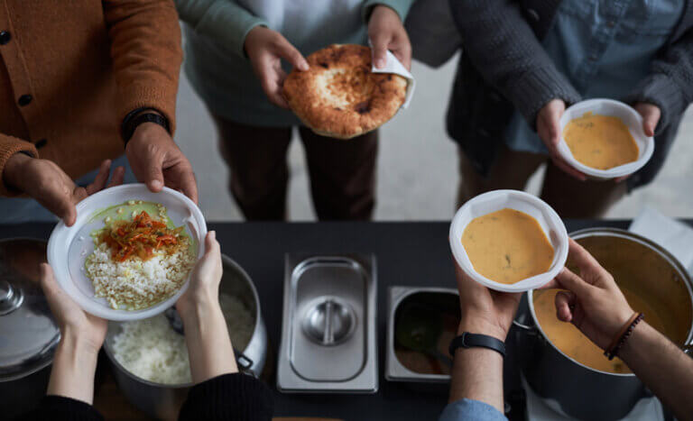 Volunteers giving out meals to people