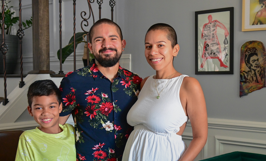 Latino family of three in their living room.