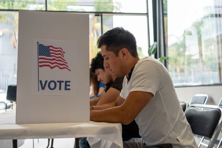 Hispanic man at voting booth