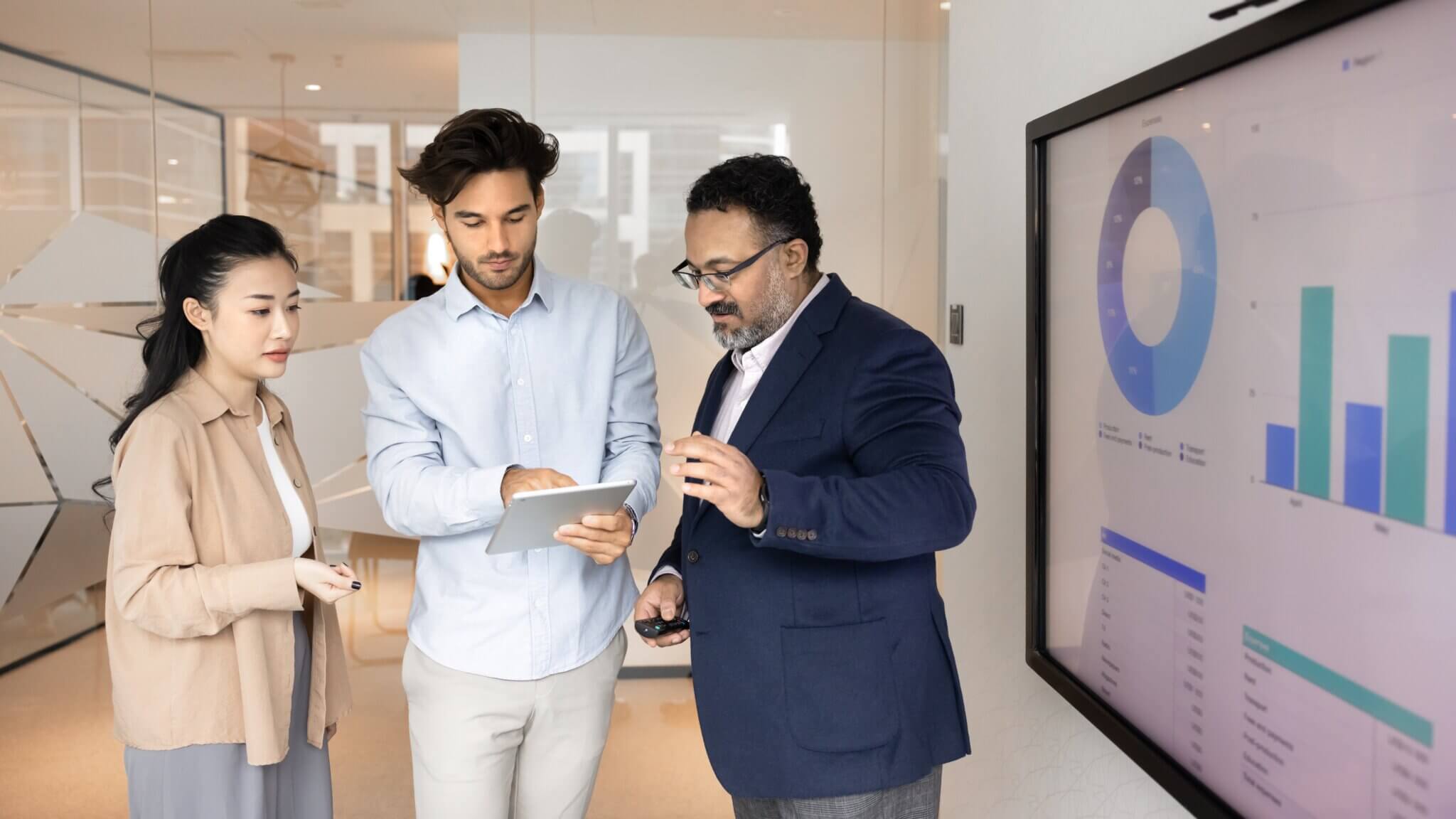 Diverse business people looking at digital tablet